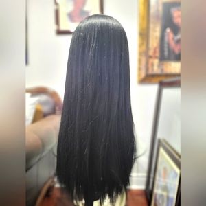 Synthetic wig with 4 × 4 lace closure 22 inches long.